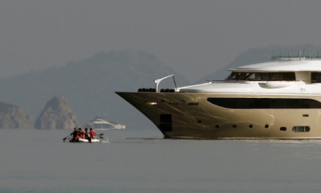 Iranian migrants cross the Aegean sea from the Turkish coast (seen in the background) to the Kos.