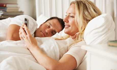 woman on phone in bed