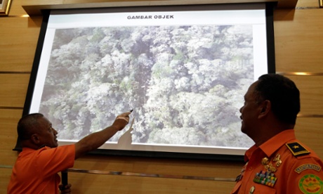 Search officials in Papua show an aerial photograph of the Trigana Air crash site.