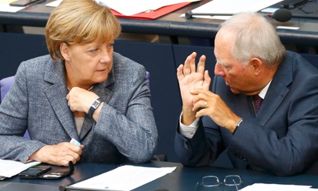 German Chancellor Angela Merkel talks with Finance Minister Wolfgang Schaeuble prior to a vote on Greece's third bailout programme during a session of Germany's parliament,
