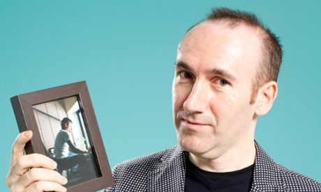 'I look at this photograph whenever I need a reminder that life is harder for others than it will ever get for me': Stephen Kelman holding a picture of his friend Bibhuti Nayak.