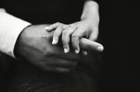 Maryam holds on to her father's finger.