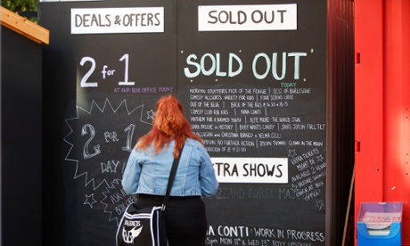 A woman looks at a Sold Out board at the Edinburgh festival in 2014