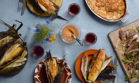 a feast of barbecued steak with grilled corn and potato gratin