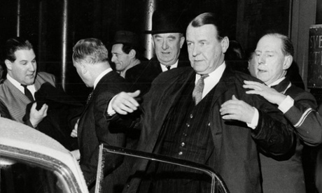 A hotel porter assists Sir William Mars-Jones with his gown. Photograph: Gordon Priestley/Associated Newspapers/REX
