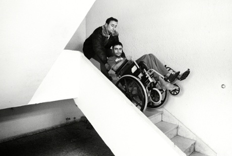 Odai is helped down the stairs by his brother Abdullah. 