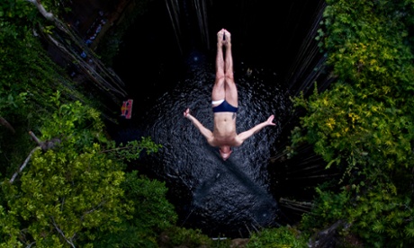 In this photo released by Red Bull, Slava Polyeshchuk, of the Ukraine, dives into the Ik Kil cenote during the second stop of the Red Bull Cliff Diving World Series in Chichen Itza, Yucatan state, Mexico, Sunday April 10, 2011. Polyeshchuk placed third. (AP Photo/Dean Treml, Red Bull)