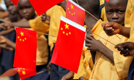 Liberian children with Chinese flags welcome a visit by arrival of China's President Hu Jintao.
