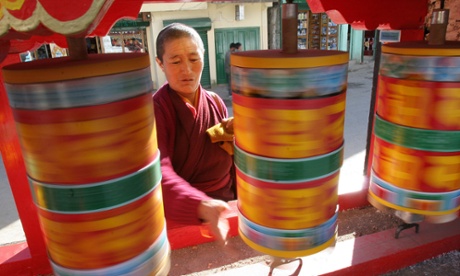 A monk spins prayer wheels at Tawang monastery, Arunachal Pradesh.