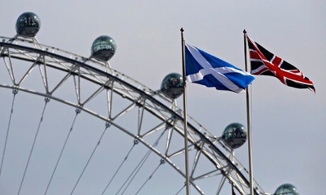 A Scottish Saltire flag and British Union flag fly together with the London Eye behind in London