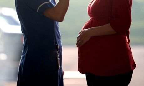 Midwife talking to a pregnant woman. 