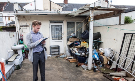 A council planner inspects an apartment built in the back of a house.
