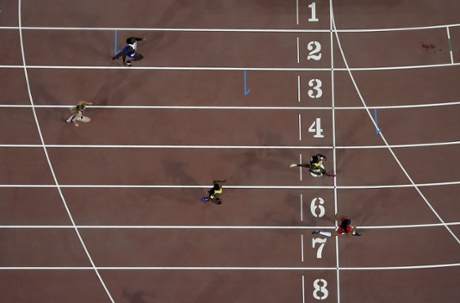 Allyson Felix crosses the line to win her women's 400 metres semi-final, closely followed home by Shericka Jackson.