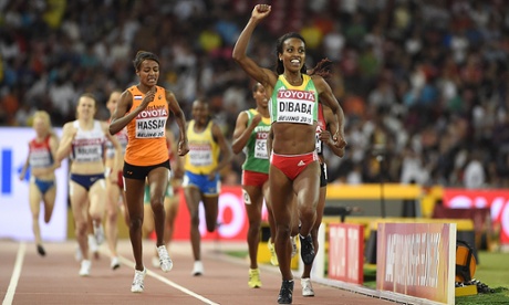 Ethiopia's Genzebe Dibaba celebrates as she approaches the line to win gold.