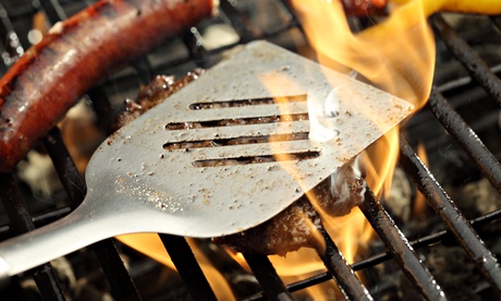 Barbecue grill with flames coming on to sausage