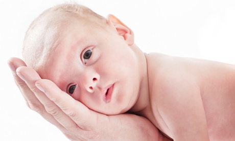 baby lying down on hand