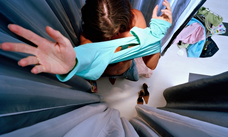 Woman trying on shirt