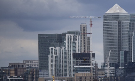 Youngsters take selfies backdropped by the view of the Canary Wharf business district in London, which includes the headquarters building of HSBC, Tuesday, June 9, 2015.  HSBC Holdings, Europe's largest bank by market value, will cut up to 25,000 jobs globally to reduce costs and shift its center of gravity further toward the fast-growing Asian economies where it started operations 150 years ago. (AP Photo/Matt Dunham)