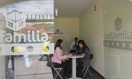 A Credifamilia loan officer discusses financing options with a prospective homebuyer.