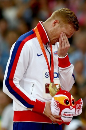 An emotional Greg Rutherford receives his Long Jump gold medal.