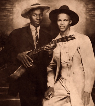 Blues singer-songwriter and guitarist Robert Johnson (1911-1938), left, with fellow blues musician Johnny Shines (1915-1992), circa 1935.