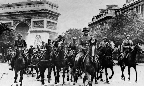 German cavalry soldiers ride through Paris in 1940 after occupying the city.
