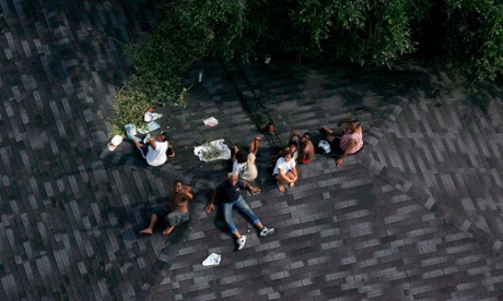 A family sitting trapped atop a roof during Katrina.
