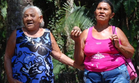 Francisca Rodrigues dos Santos (on the left), from Piaui, singing with a fellow quebradeira holding a babassu fruit.