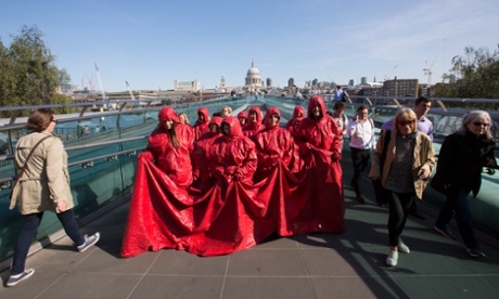 Artist Nicola L, right, escorts the 11 volunteers in her Red Coat to Tate Modern.