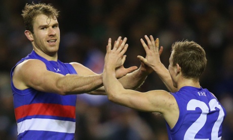Bulldogs forward Stewart Crameri and Mitch Honeychurch celebrate a goal as their side defeats North Melbourne at Etihad Stadium