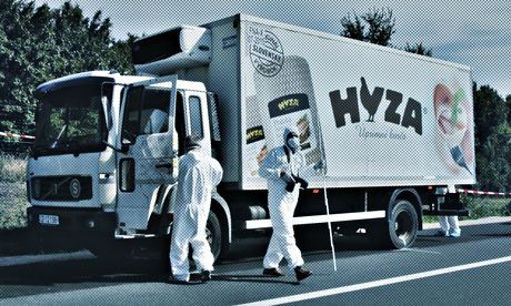 Forensic police officers inspect the truck in which up to 50 migrants were found dead on a motorway 