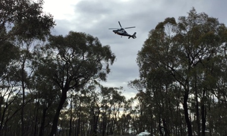 The Victorian police Air Wing hovers above the treetops outside Bendigo in the search for a missing female student last Thursday