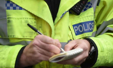 Police officer writes in a notebook