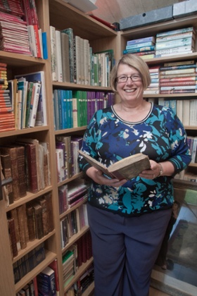 Author Louise Allen in her shed with her historical book collection.