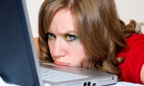 Woman frustrated at her computer keyboard