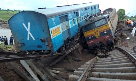 A locomotive and a carriage lie side by side at the crash scene outside Harda in Madhya Pradesh state.
