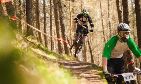 Student David Barr rides a mountain bike downhill.