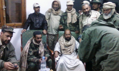 With his captors in November 2011