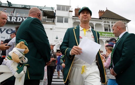 Michael Clarke holds his teamsheet as he comes out for the toss.