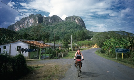 Girl cycle touring in Vinales region of Cuba
