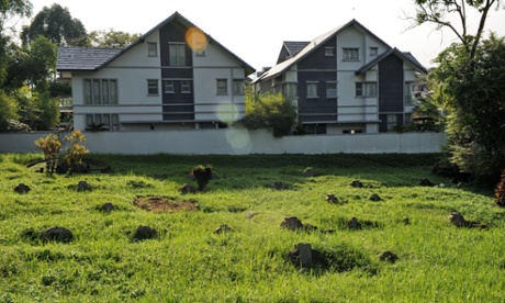Private homes encroaching on grave sites at Bukit Brown cemetery.