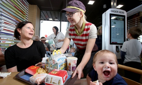 Carla Rogers delivers food to Jenny Wilson and her son Ted at the McDonald's at Hyde, in Greater Manchester.