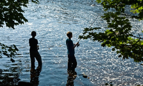 Two boy anglers fishing in River Wharfe, West Yorkshire in 2010.