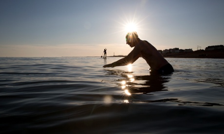 David Batchelor standing silhouetted in water