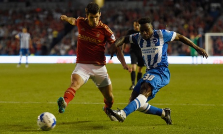 Kazenga LuaLua of Brighton scores in the first half despite the efforts of Nottingham Forest's Eric Lichaj.