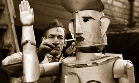 Charles Lawson, an electrical engineer from Kettering. lights his robot's cigarette in 1939. In the future, will the roles be reversed?