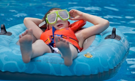 Young boy relaxing on a inflatable floating boat