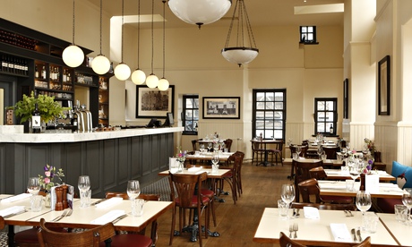 Contini Cannonball restaurant with counter, tables, two hanging lights