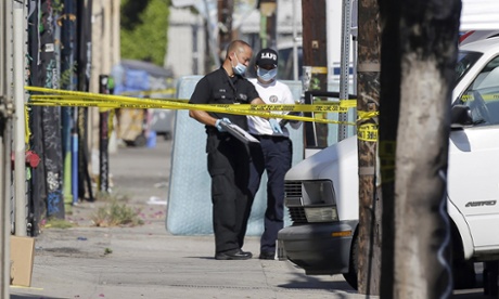Los Angeles police at the crime scene after three boys were found dead inside a car outside an elementary school.
