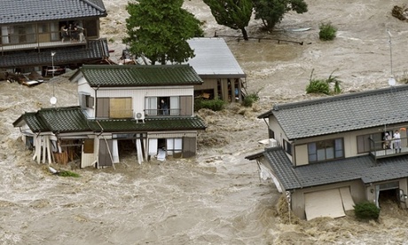 People wait to be rescued as floodwaters engulf their homes